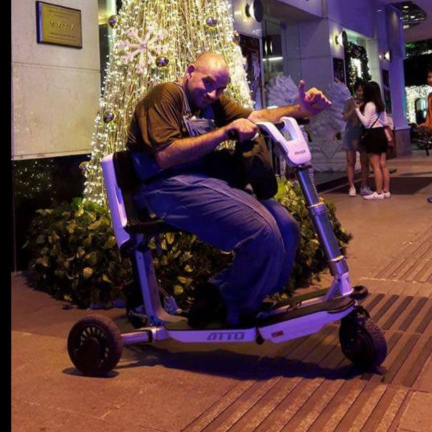 Segei, a Movinglife customer, on his ATTO portable mobility scooter. 